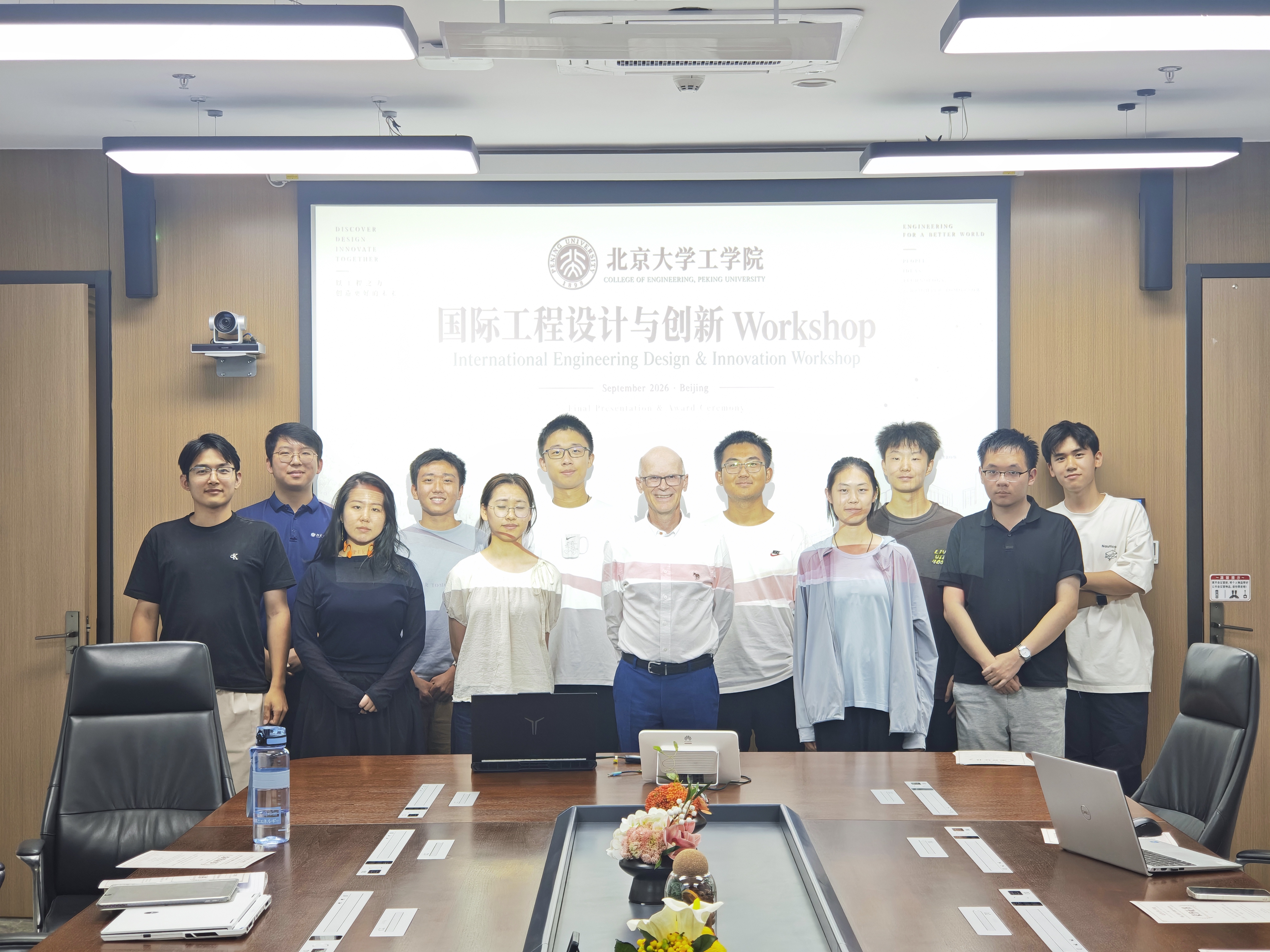 Workshop participants posing for a group photograph in a meeting room