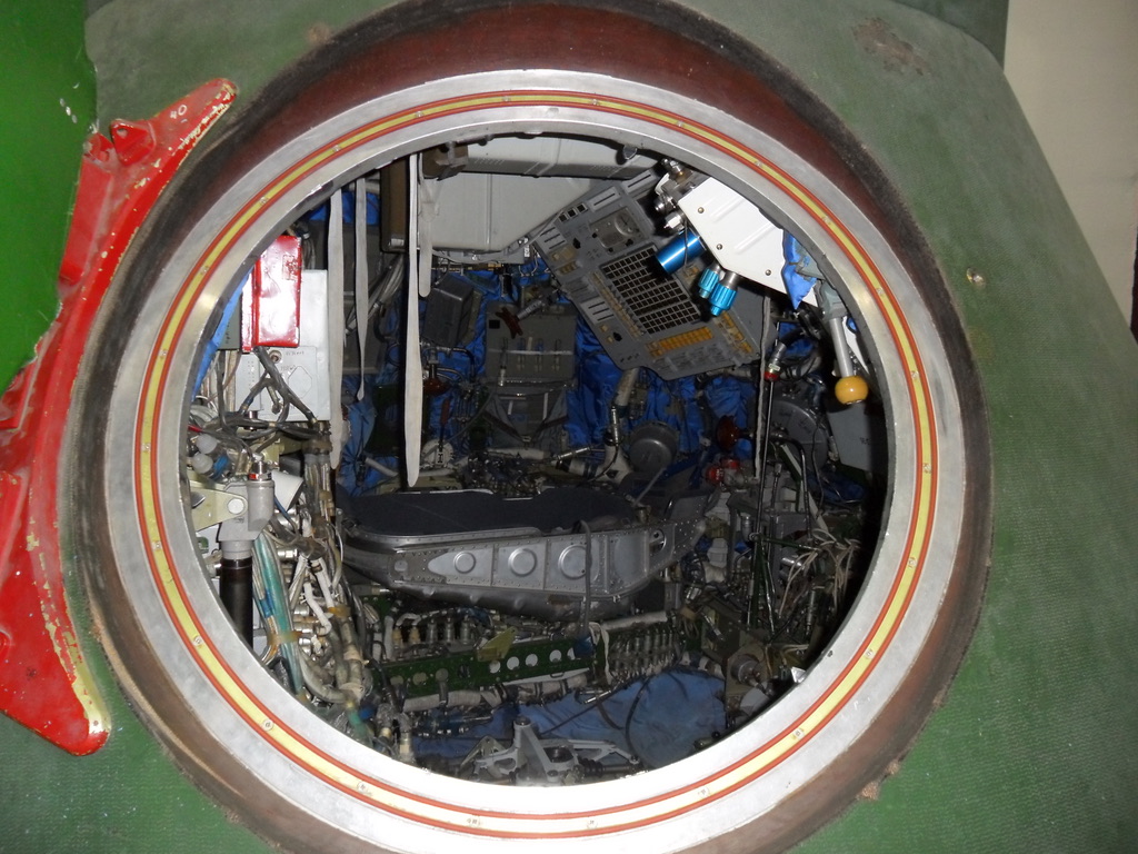 Spacecraft equipment visible through a circular hatch