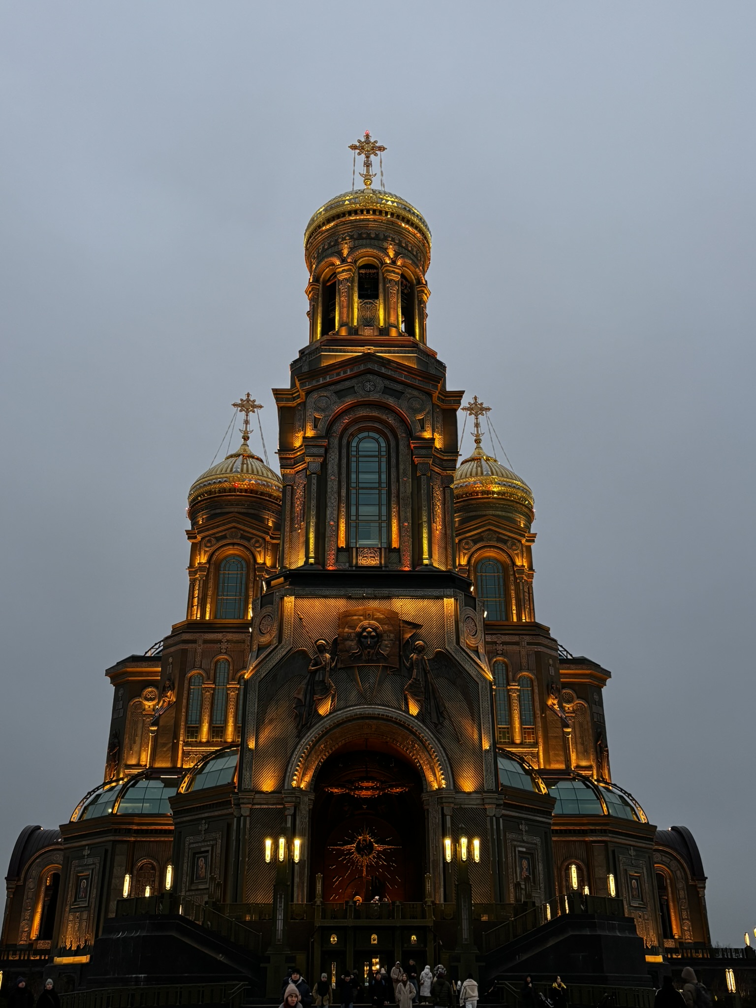 A cathedral with illuminated golden domes