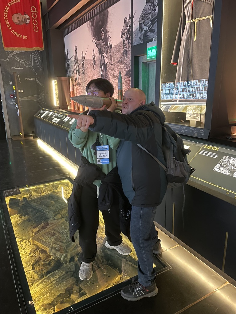 Two visitors posing beside a museum exhibit