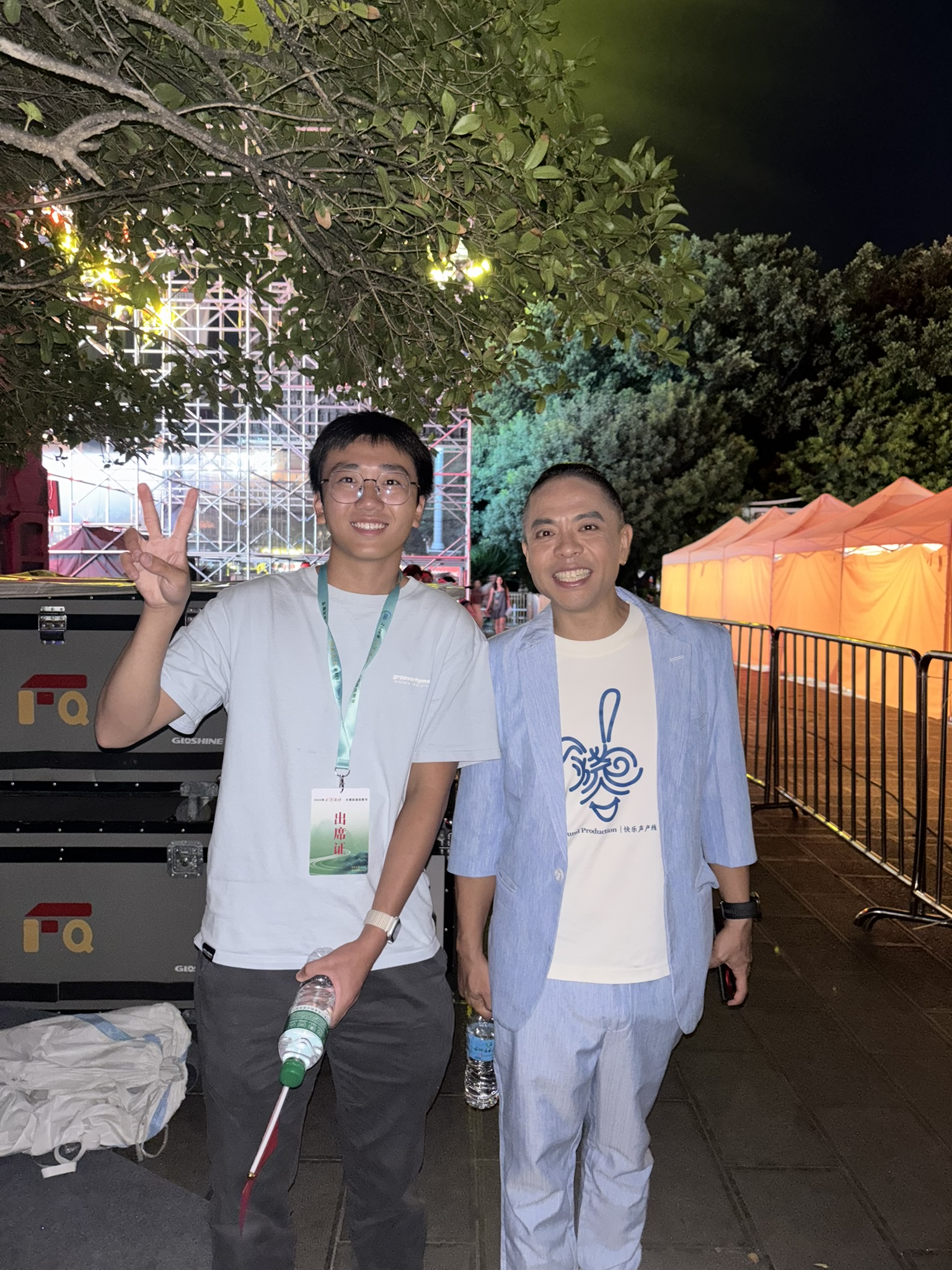 Two participants at an outdoor evening event