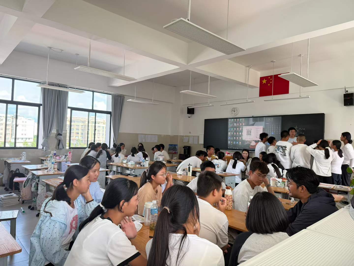 Students and program participants talking together in a classroom