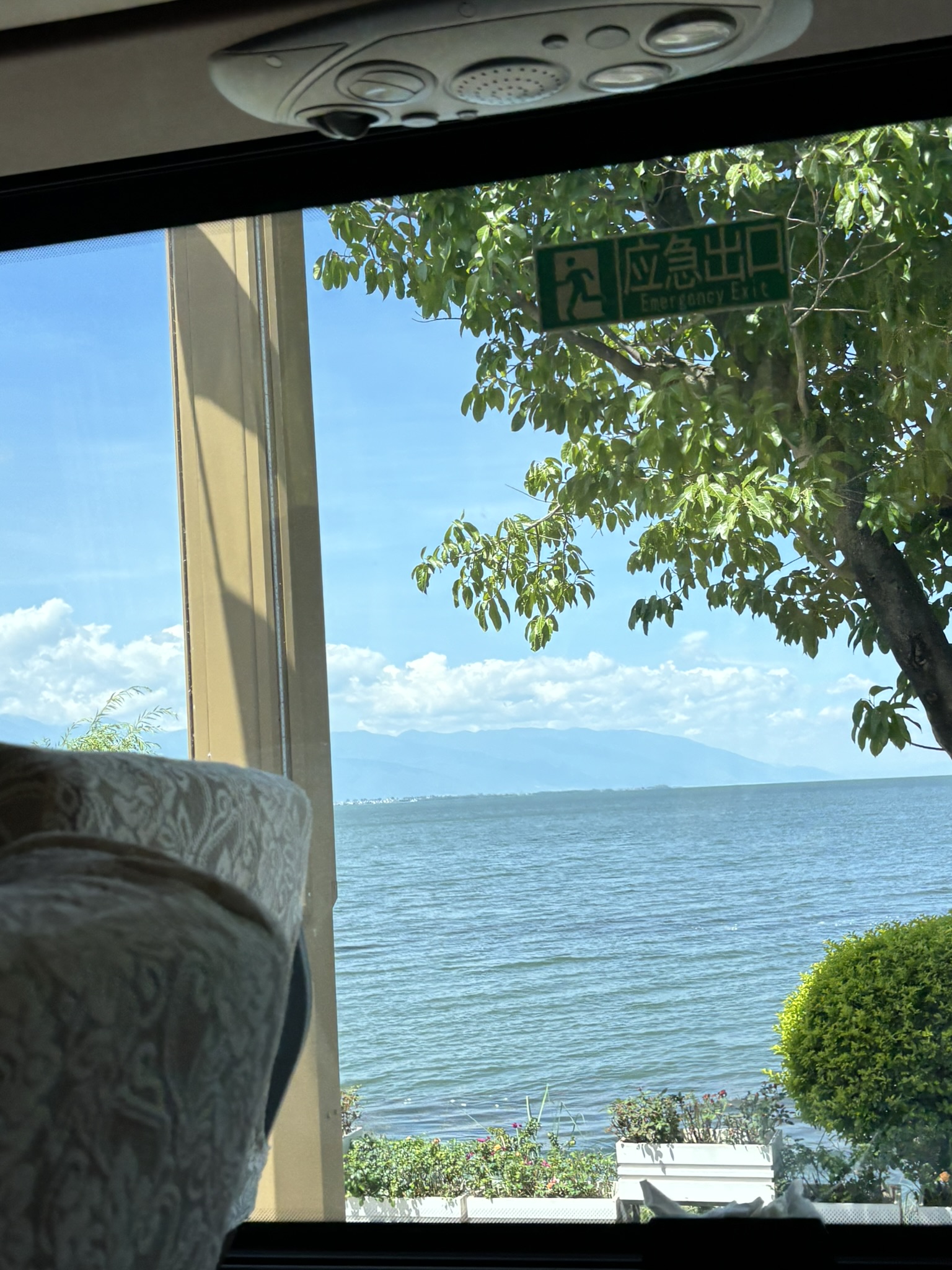 A lakeside view through a bus window