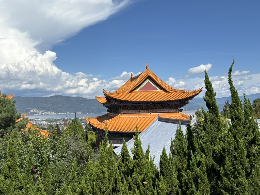 A temple overlooking a lake and mountains