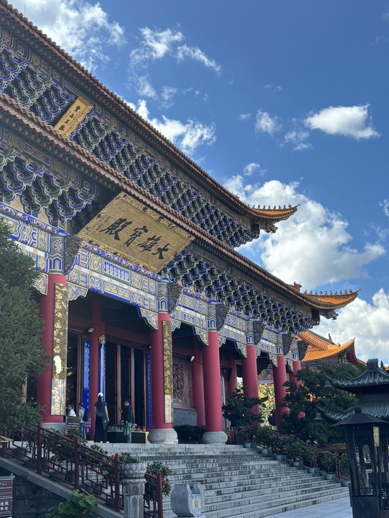 An ornate temple facade beneath a blue sky